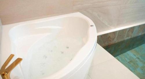 a white bath tub in a bathroom at All That Water Pension in Gapyeong
