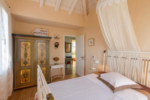 a bedroom with a white bed in a room at Villa Kate a Dreamy Summer Escape in Porto Heli