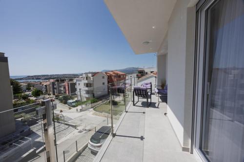 an apartment balcony with a view of a city at NU Sea View in Podstrana
