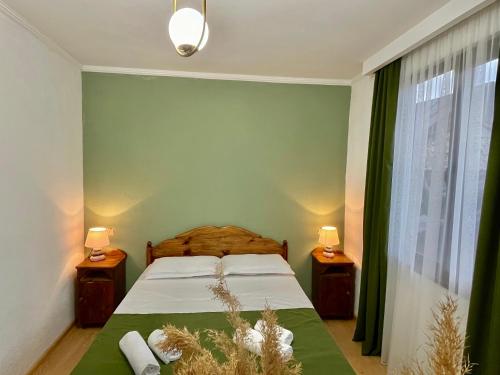 a bedroom with a bed with two night stands and two lamps at Cozy-Corner Guesthouse in Mestia