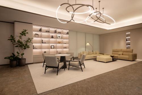 a living room with a table and chairs and a couch at Mlily Hotel in Shanghai