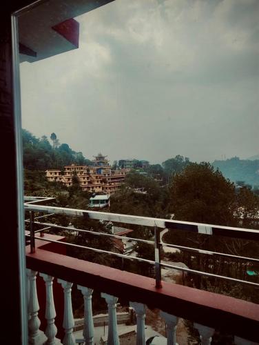 a view of a city from a balcony at Nature View Home Stay in Mandi