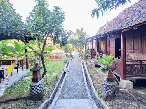 a toy track in front of a building with trees at Pondok Daun D Martin Mitra RedDoorz near UMY in Ngingas