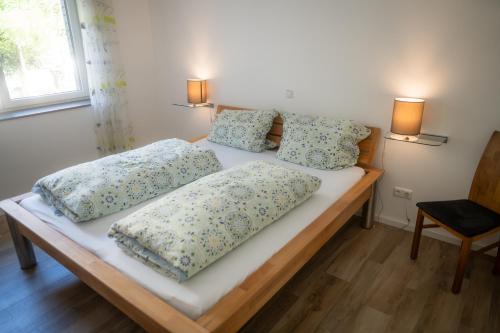 two beds with pillows on them in a bedroom at Appartement am Hostertberg 1 in Simmerath