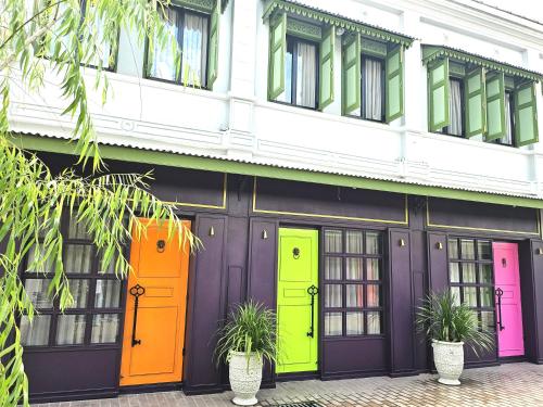 a building with colorful doors in front of it at Soho House Old Town Bangkok in Bangkok