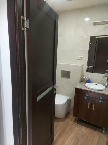 a bathroom with a toilet and a sink at Avenue apartments in Yerevan