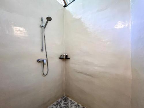 a shower stall with a shower head in a bathroom at NernJamsai in Sop Poeng