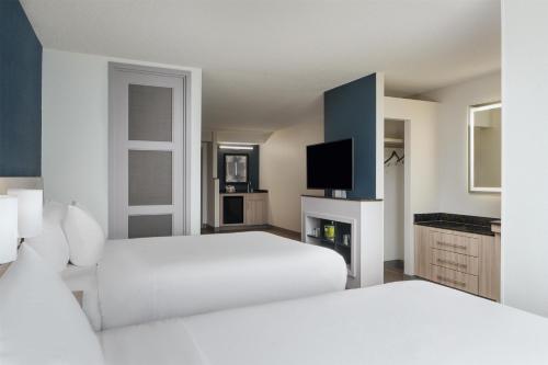 a hotel room with two beds and a tv at Hyatt Place Sacramento Rancho Cordova in Rancho Cordova