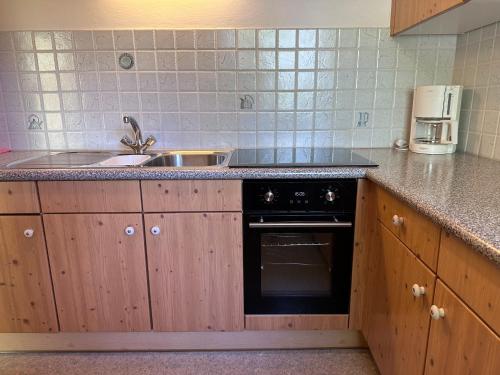 a kitchen with a sink and a stove at Chalet Josi in Leutasch
