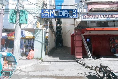 an alley with a street sign on a building at Hotel Madiaas by RedDoorz in Iloilo City