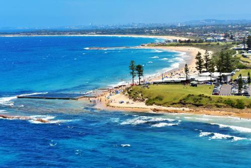 an aerial view of a beach and the ocean at Woonona Stays in Woonona