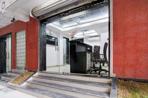 a room with sliding glass doors and a stairway at Super Collection O Chinar Park Near Airport in Kolkata