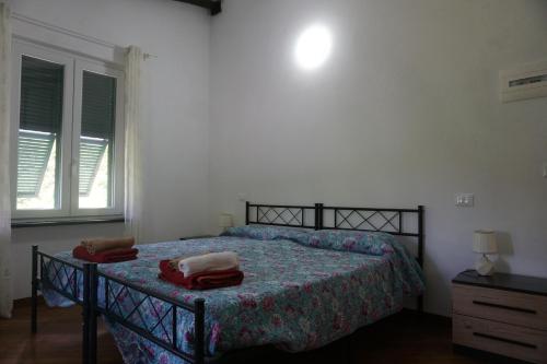 a bedroom with a bed with two towels on it at Agriturismo U muinettu in La Spezia