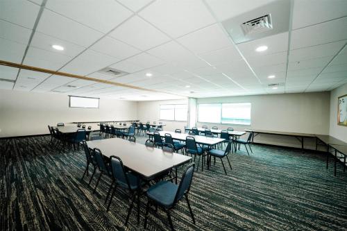 a classroom with tables and chairs in a room at AmericInn by Wyndham Tomahawk in Tomahawk