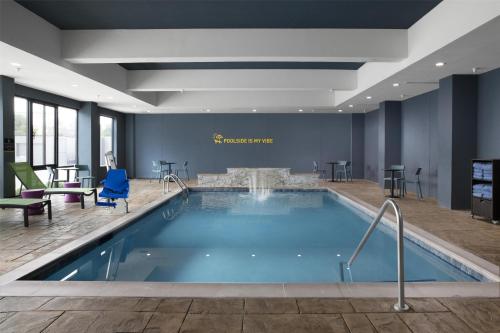 a large swimming pool in a hotel room at Home2 Suites By Hilton Dallas East in Dallas