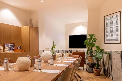 a conference room with a long table and chairs at Hotel SAX Paris, LXR Hotels & Resorts in Paris