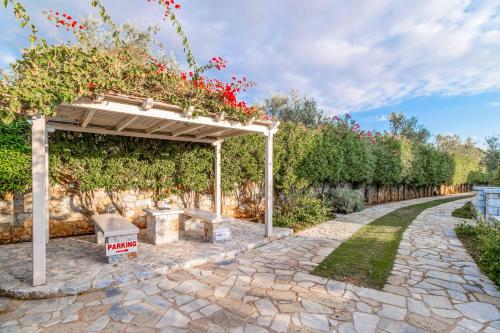 a garden with a pergola and a walkway at Villa Panorama in Levktron