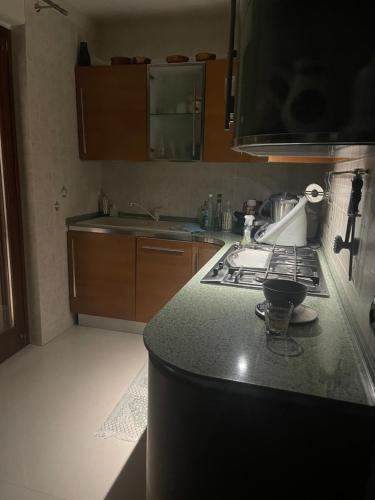 a kitchen with a stove and a counter top at Fenix Villa in Noicattaro
