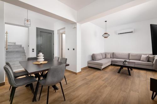 a living room with a table and a couch at Villa Vasaltis & Selestitis in Gennadi