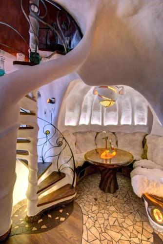 a room with a table and a couch and a room with a table at Pensjonat Absynt in Nowy Targ