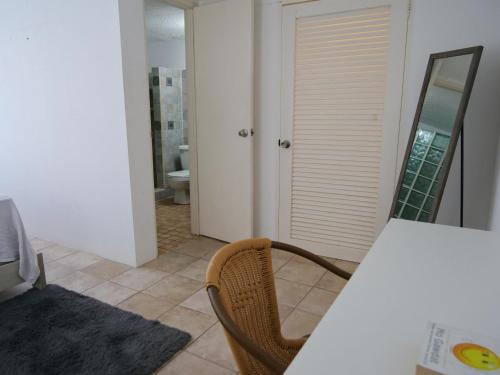 a room with a table and a chair and a bathroom at Villa Spinoza- Lux Pool, Garden, Retreat & Beach in Philipsburg