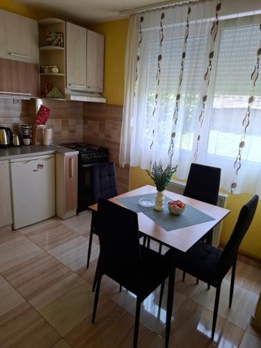 a kitchen and dining room with a table and chairs at DMB Apartments in Kragujevac