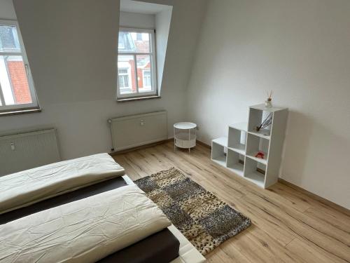 a bedroom with a bed and a white cabinet at Schönes Apartment mit Infrarot Sauna und Balkon in Plauen