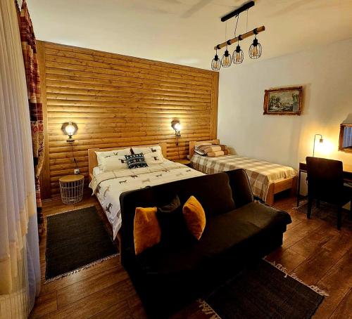 a bedroom with a bed and a couch at Zimski san in Ravna Gora