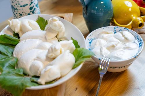 a bowl of dumplings on a table with a fork at Opera Hotel in Gravina in Puglia