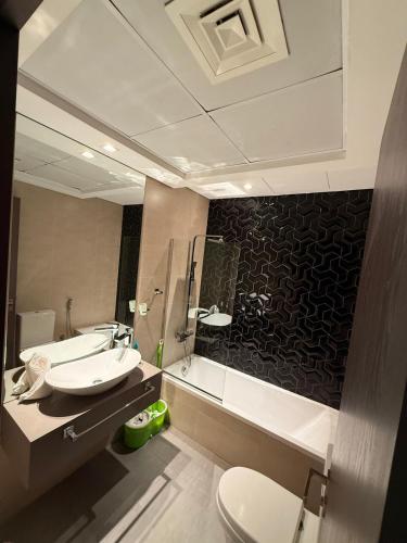 a bathroom with two sinks and a mirror at Stunning Park View 1Bhk 4pax in Dubai