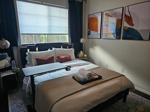 a bedroom with a bed with a tray on it at Tranquility at the House of Alchemy Hollywood in Los Angeles