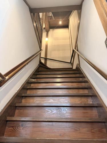 a staircase leading up to a building with wooden floors at Zenya-Nakano in Nakano