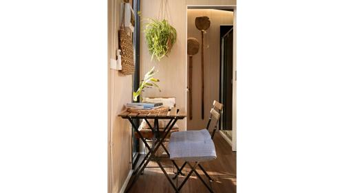 a small table in a hallway with a chair at Tiny Zahalka House by Tiny Away in Daylesford