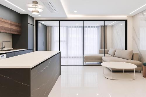 a kitchen and living room with a couch and a table at Zizel Suite Room Seocho in Seoul