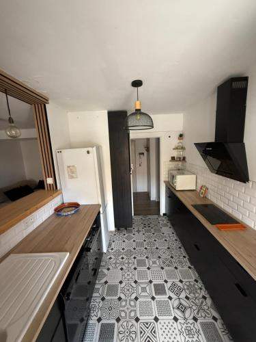 Il comprend une cuisine dotée de carrelage et d'un réfrigérateur. dans l'établissement Bel appartement centre Aix, à Aix-en-Provence