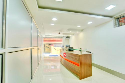a lobby with a wooden counter in a building at Hotel O Shakti Inn in Jamshedpur