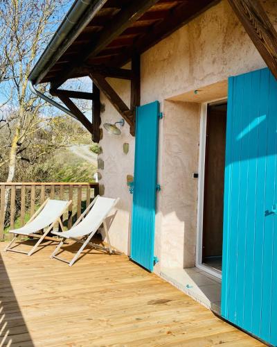 une paire de chaises assises sur le pont d'une maison dans l'établissement Ô fil 2 l'eau - Le GITE en bord de LOIRE, à Saint-Maurice-sur-Loire