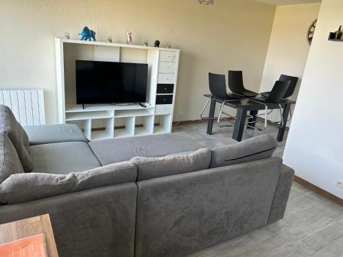 un salon avec un canapé et une télévision à écran plat dans l'établissement Appartement Evreux, à Évreux