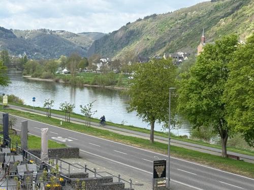 a road next to a river next to a mountain at Weinbergs Loge in Ernst