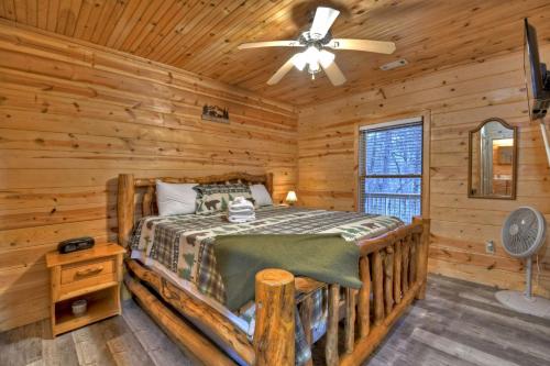 a bedroom with a bed in a log cabin at The Waters Edge Game room creek access firepit and tons of outdoor space in Copperhill