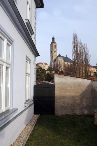 a white building with a wall and a window at Comfortable apartments under the St. Barbara´s Cathedral in Kutná Hora