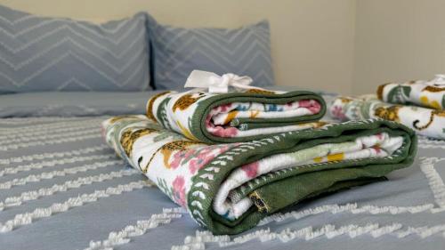 a pile of blankets sitting on top of a bed at Central Guest Studio - En-Suite - Vibrant London in London
