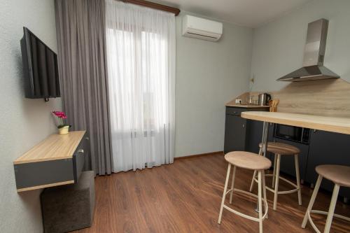 a kitchen with a counter and stools in a room at Hillside Guest House in Yerevan