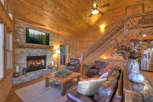 a living room with a couch and a fireplace at View-Topia STUNNING VIEWS - Hot tub - Gameroom in Blue Ridge