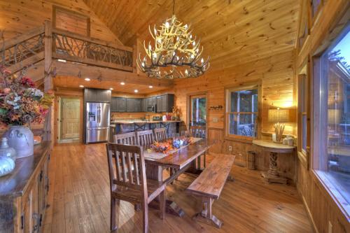 a dining room and kitchen with a table and a chandelier at View-Topia STUNNING VIEWS - Hot tub - Gameroom in Blue Ridge