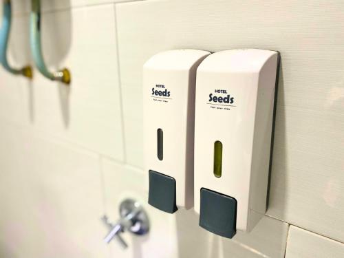 two rolls of toilet paper on the wall of a bathroom at Seeds Hotel Cheras Maluri in Kuala Lumpur