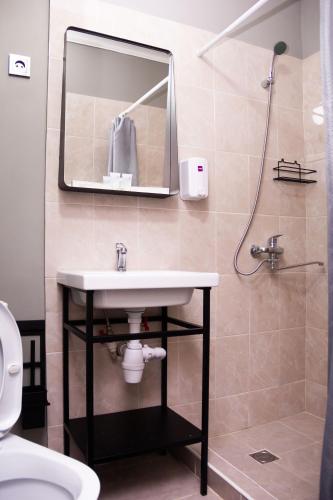 a bathroom with a sink and a mirror at Hotel Tahar in Almaty