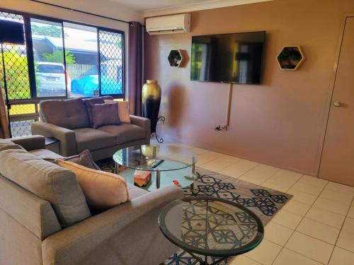 a living room with a couch and a table at Chill out space close to town in Westcourt