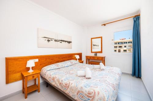 a bedroom with a bed and two nightstand tables at Can Vidal Cabrera in Ses Salines