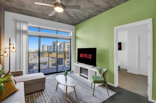 a living room with a couch and a tv at Centric 2BR In HEART of DTPHX Free Garage Parking in Phoenix